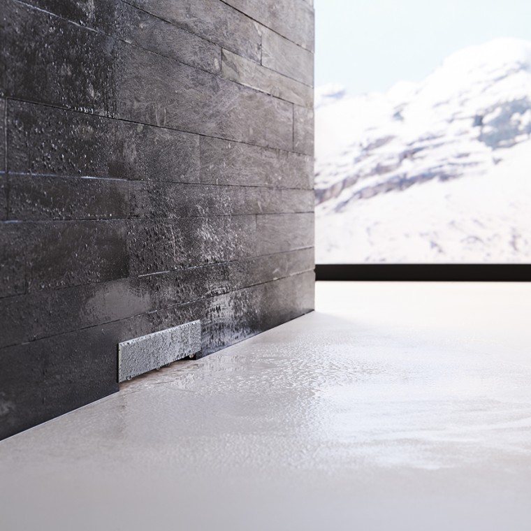 Ecoulement mural Geberit dans un mur de briques noires Ecoulement mural Geberit dans un mur de briques noires