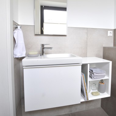 Vue sur la salle de bains dʼinvités avec lavabo et armoires Vue sur la salle de bains dʼinvités avec lavabo et armoires